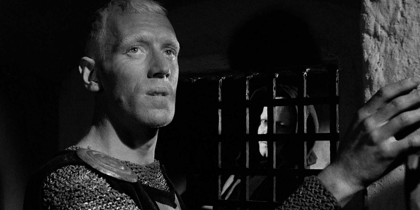 Antonius Block, with someone looking at him from behind bars, in The Seventh Seal