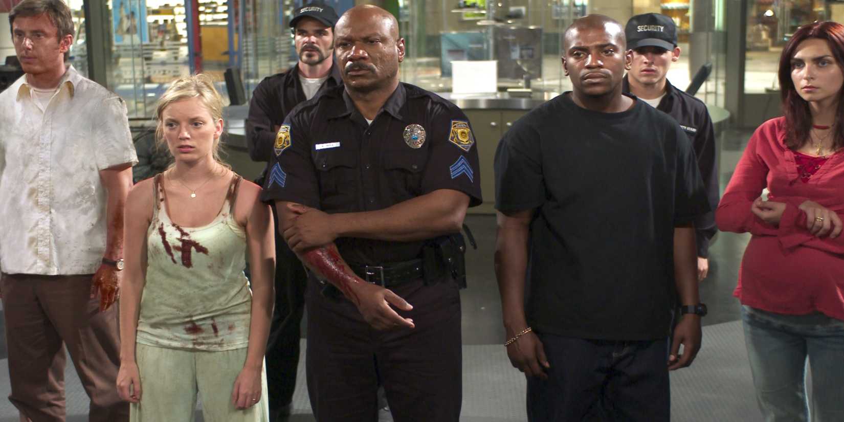 The cast of Dawn of the Dead stand in a mall.