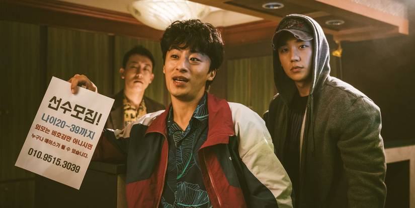 Jung Hae-in and Koo Kyo-hwan as Jun-ho and Ho-yeol holding a sign in DP.