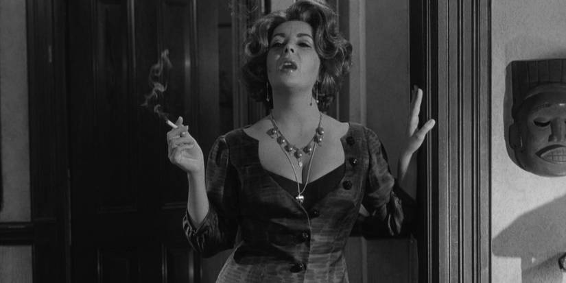 Elizabeth Taylor as Martha smoking and standing with her mouth open in Who's Afraid of Virginia Woolf
