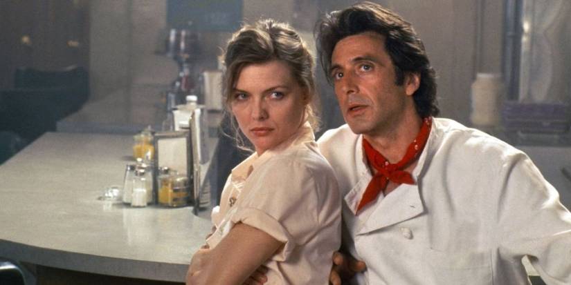 Michelle Pfeiffer and Al Pacino in a diner looking up at something in Frankie-and-Johnny