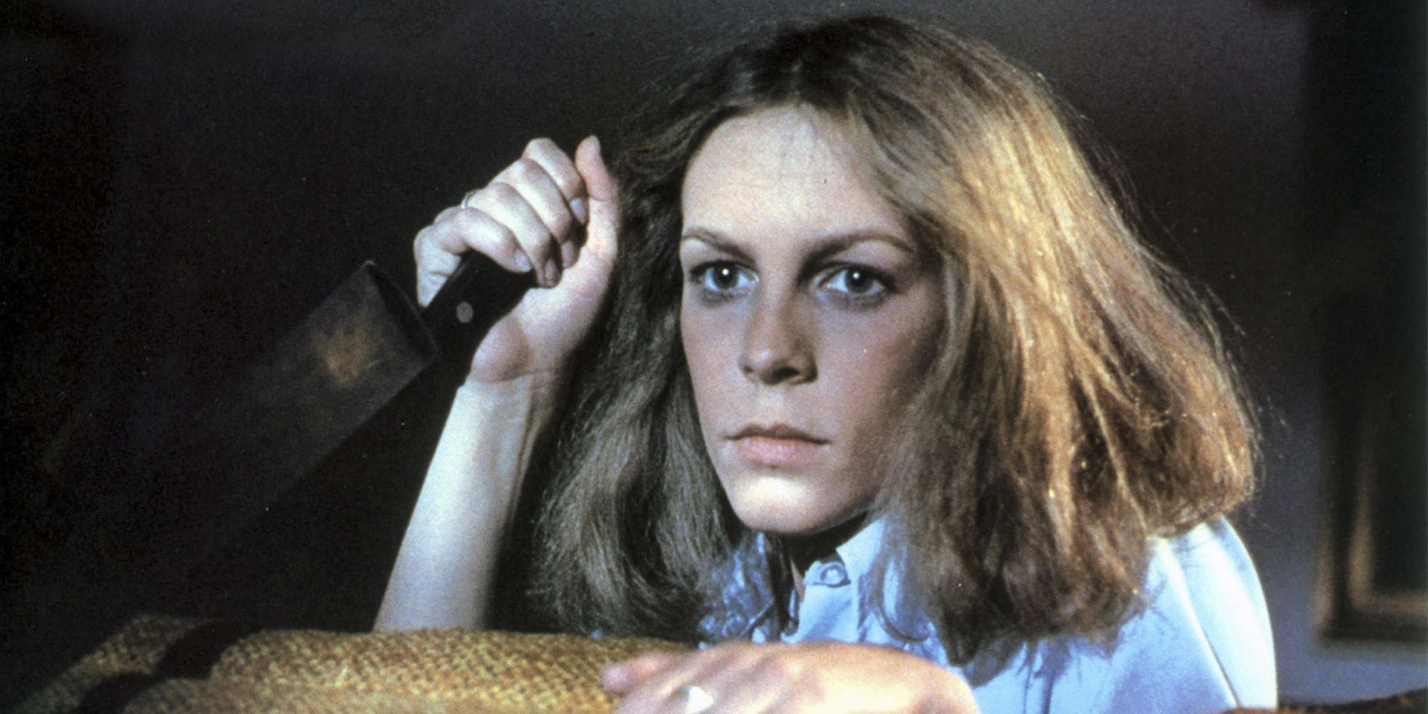 Laurie Strode holding a knife and looking scared in 'Halloween' (1978)