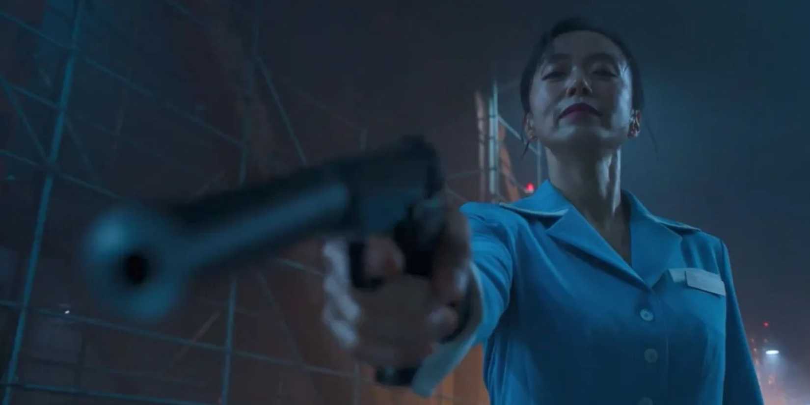 A woman aiming a gun down at someone off-camera in Kill Boksoon’ (2023)