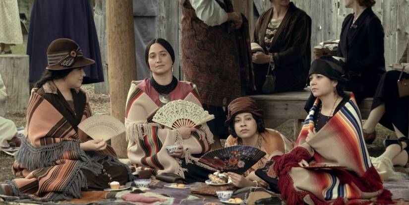 JaNae Collins, Lily Gladstone, Cara Jade Myers, and Jillian Dion sitting together in Killers of the Flower Moon