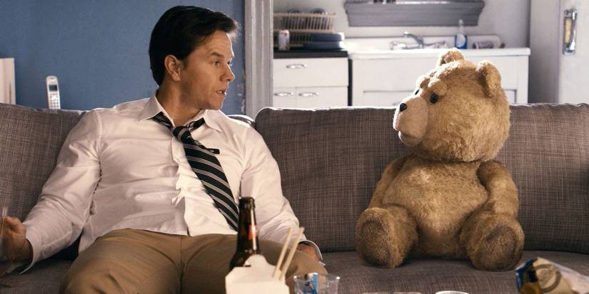 John and Ted sitting in a couch and looking at each other in Ted 2012