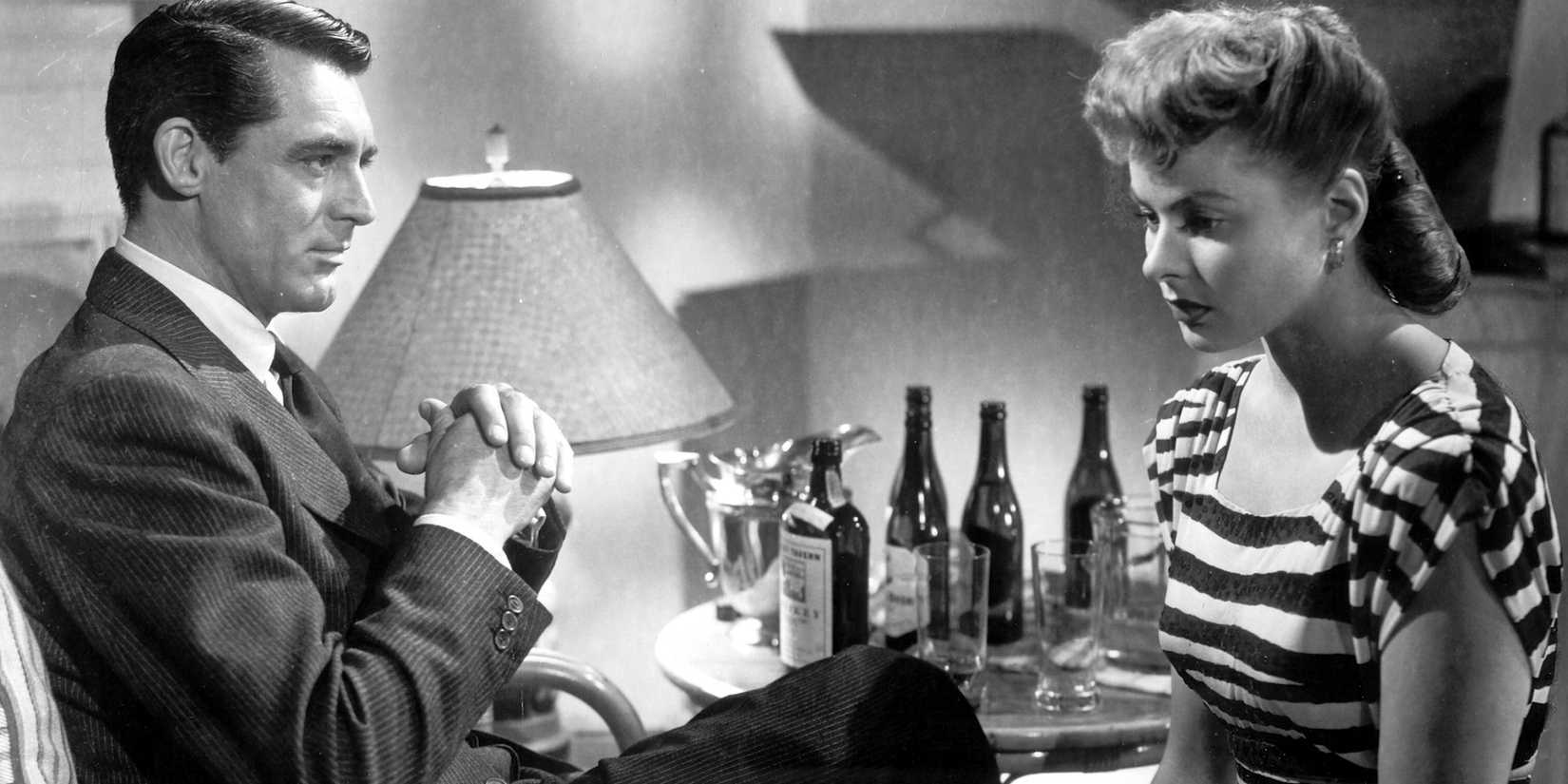 Cary Grant and Ingrid Bergman sitting somberly in Alfred Hitchcock's 'Notorious'