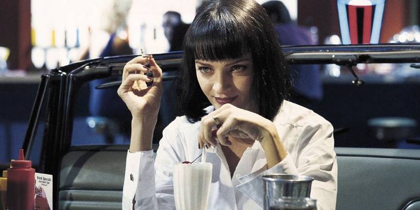 Mia Wallace drinking a milkshake and smoking in a diner in Pulp Fiction