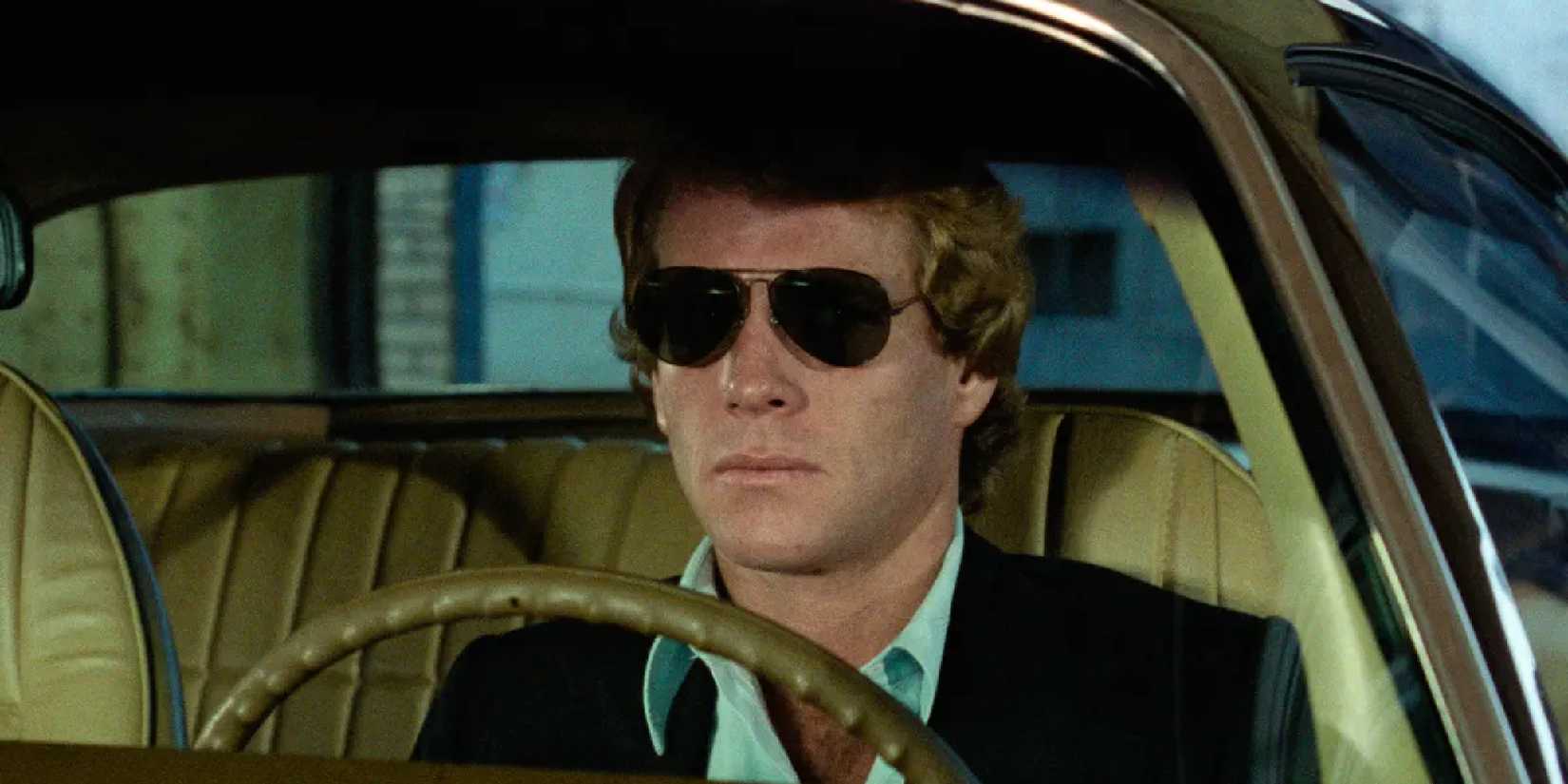 Ryan O'Neal inside a car in The Driver