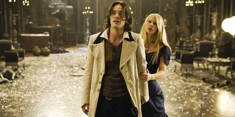 Yvaine, a fallen star, clutches onto Tristan's arm in a large room with broken glass everywhere.