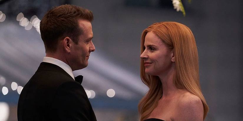 Gabriel Macht as Harvey Specter with Sarah Hafferty as Donna Paulsen, smiling at one another in Suits