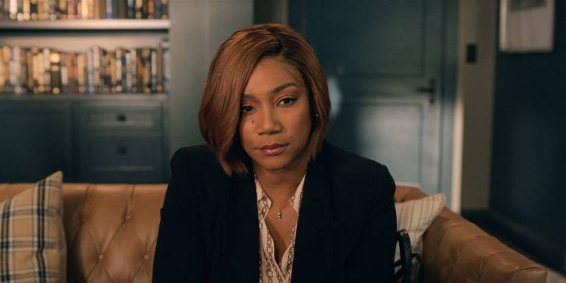 Tiffany Haddish sitting on a couch and staring ahead in The Afterparty Season 2, Episode 2.