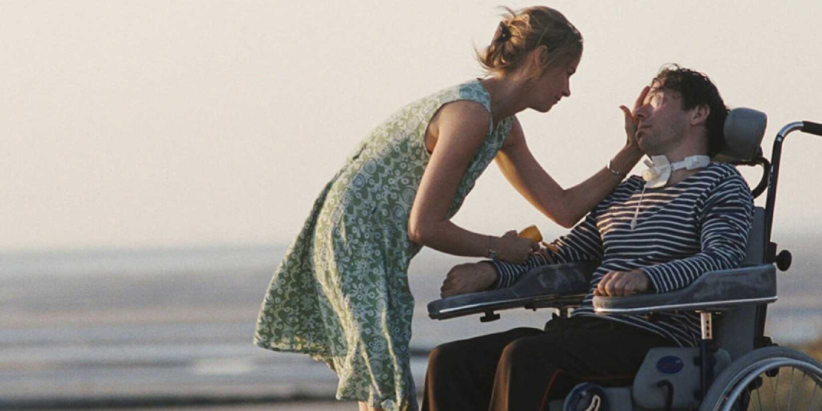 Anne Consigny touches Mathieu Amalric in a wheelchair in The Diving Bell and the Butterfly