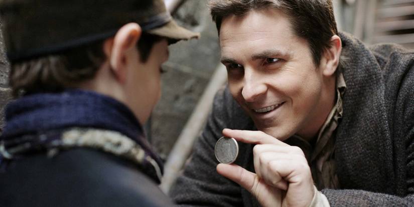 Christian Bale's Alfred Borden performing a magic trick with a coin for a child in The Prestige.