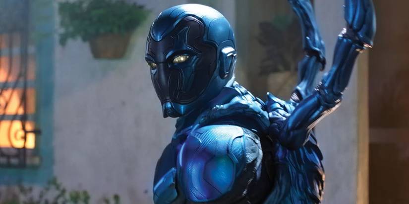 Xolo Maridueña as Blue Beetle turning around in Blue Beetle.