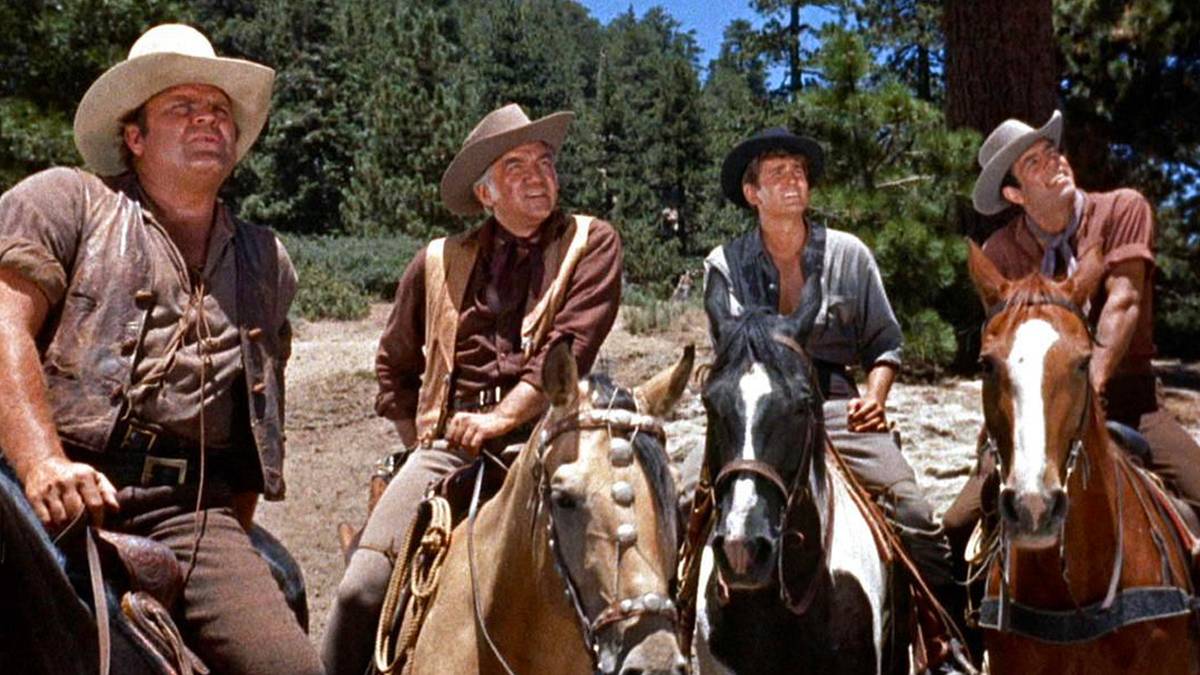 Lorne Greene, Pernell Roberts, Dan Blocker and Michael Landon as Ben, Adam, Hoss, and Joe Cartwright, riding horses and looking at the sky in Bonanza.