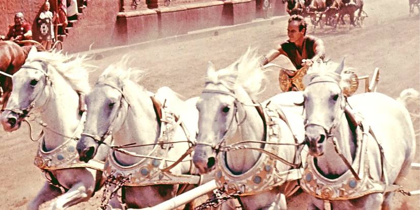 Charlton Heston steering white horses in a chariot race in Ben-Hur (1959)