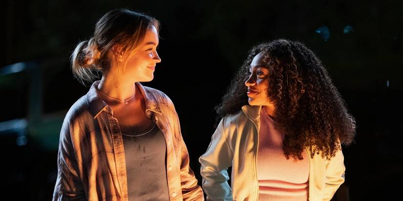 Sadie Stanley as Megan and Lexi Underwood as Isabella smile at each other in Cruel Summer Season 2. 