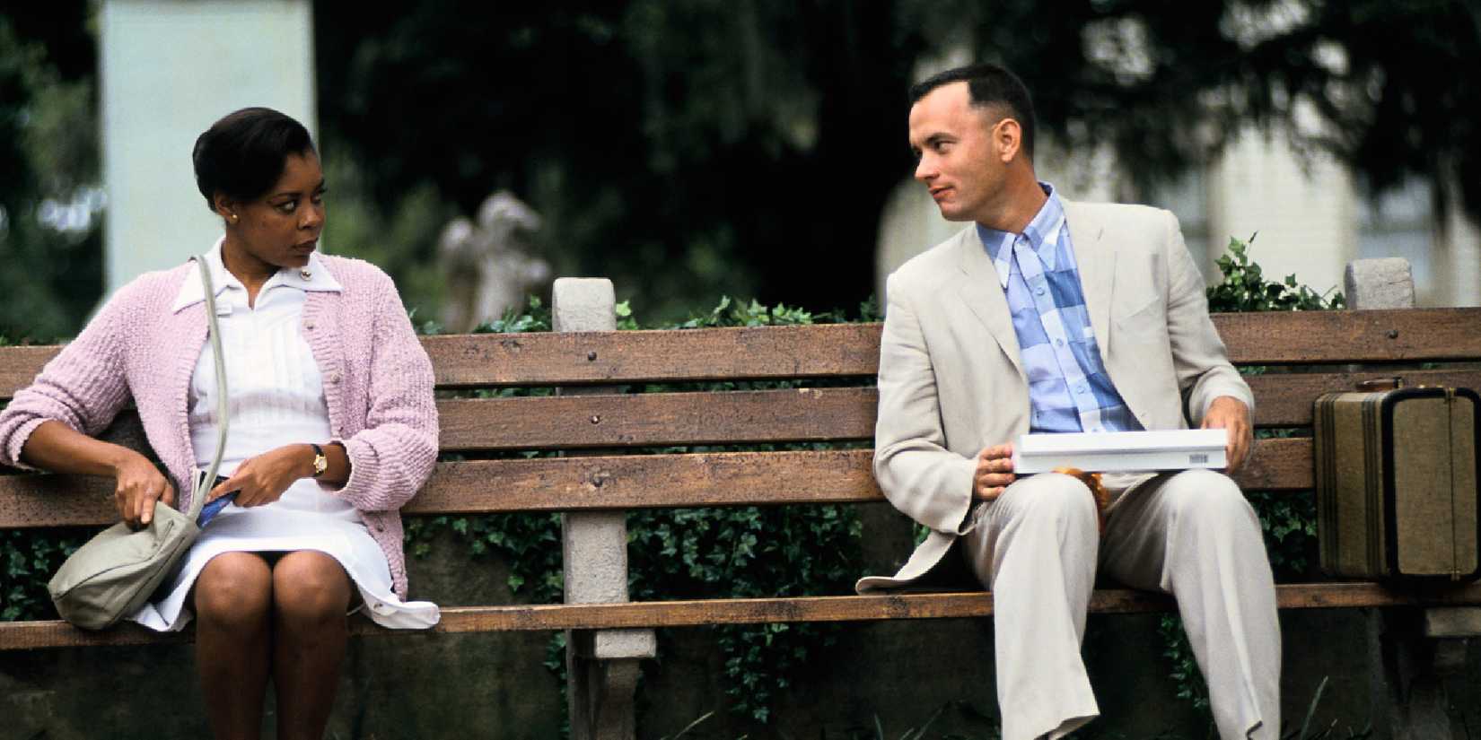 Forrest Gump talking to a nurse while sitting on a park bench in Forrest Gump