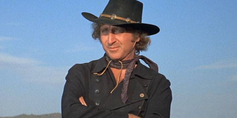 Gene Wilder as Jim the Waco Kid sitting with his arms crossed in Blazing Saddles