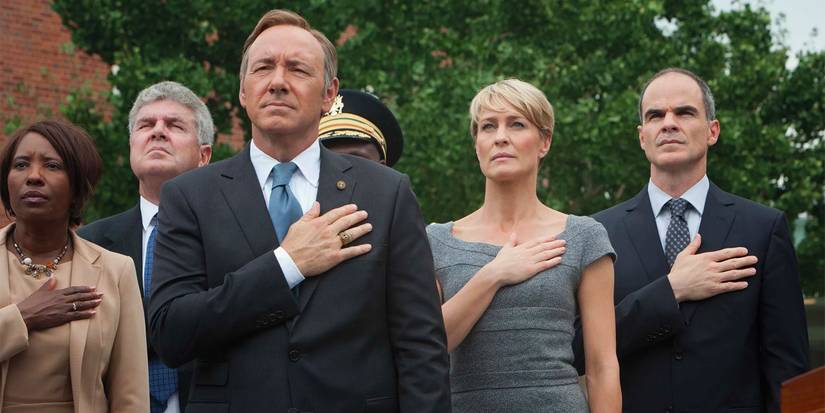 Frank (Kevin Spacey), Claire (Robin Wright) and Doug (Michael Kelly) hands over hearts in House of Cards.