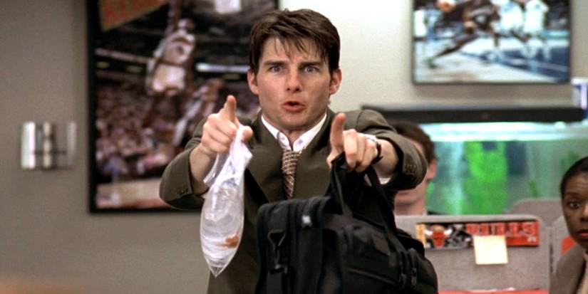 Tom Cruise as Jerry Maguire holding his briefcase and a goldfish in a plastic bag