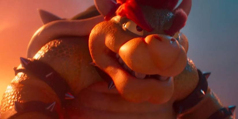 Bowser lit by fire looking intently in The Super Mario Bros. Movie.