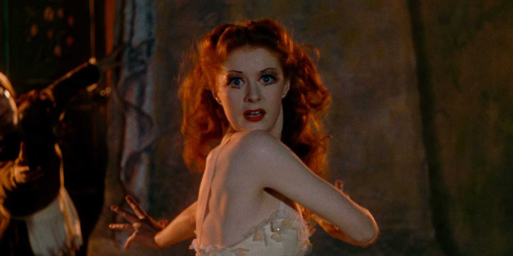 Moira Shearer as Victoria looking at the camera while dancing in The Red Shoes.