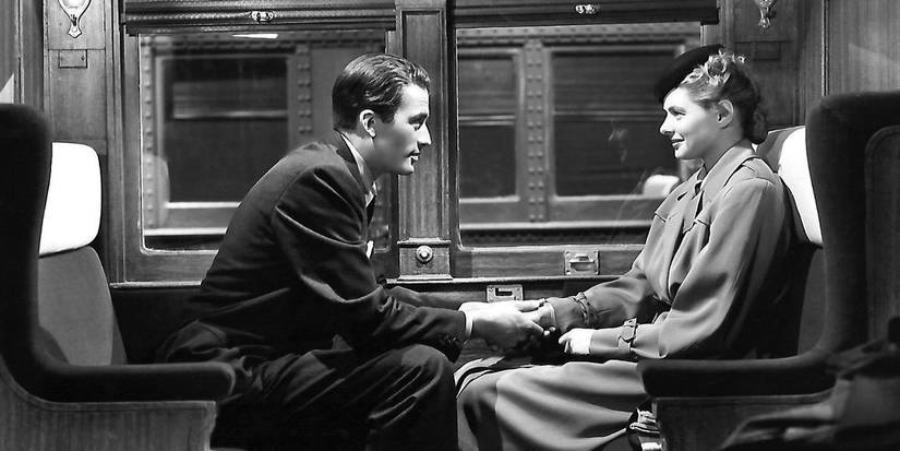 Anthony and Constance on a train holding hands and gazing into each other's eyes in Spellbound