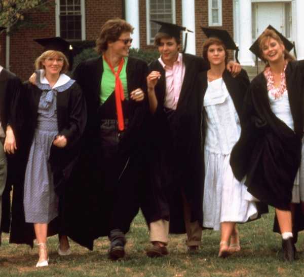 The Cast of St. Elmo's Fire wearing their caps and gowns as they walk through their university quad.