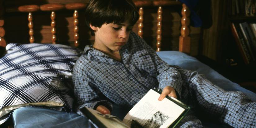Noah Hathaway in The NeverEnding story holding a book