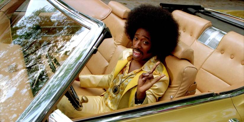 Eddie Griffin as Undercover Brother in car giving a peace sign