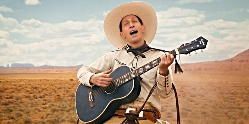 Tim Blake Nelson as Buster Scruggs, singing and playing his guitar in the desert in 'The Ballad of Buster Scruggs'