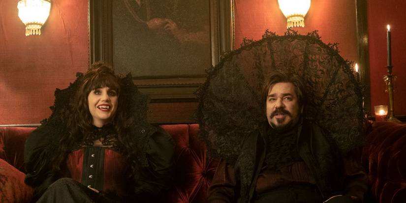 Nadja, played by Natasia Demetriou, and Laszlo, played by Matt Berry, laughing in What We Do in the Shadows.