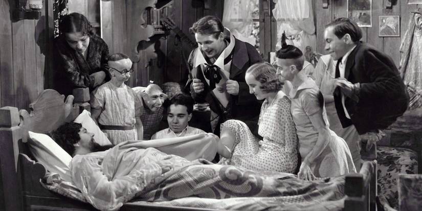 The cast gather around the Bearded Lady's (Olga Roderick) bedside in Freaks (1932).