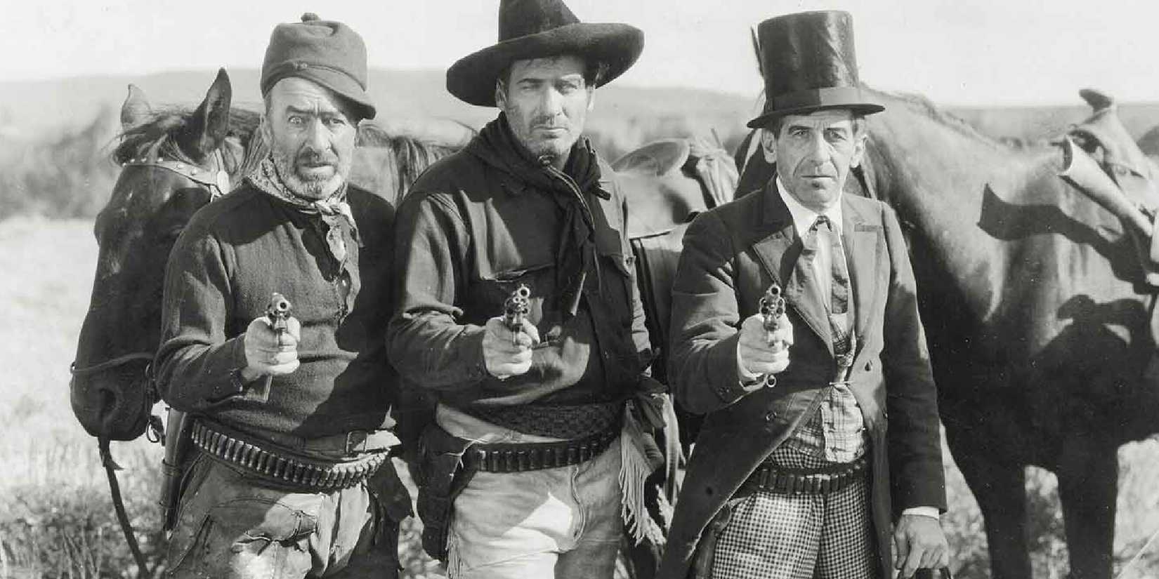 Three men aiming guns at the camera in 3 Bad Men