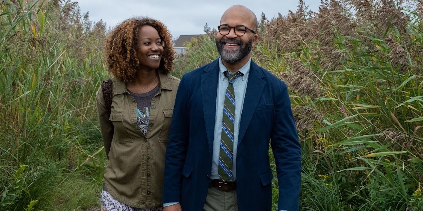 Coraline and Monk Ellison smiling while walking in tall grass in American Fiction. 