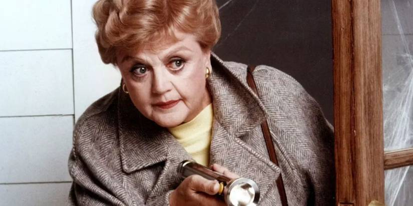 Angela Lansbury as Jessica Fletcher holding a flashlight and looking around a corner in Murder, She Wrote.