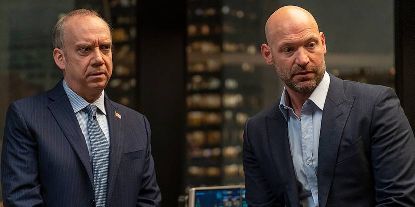 Corey Stoll and Paul Giamatti as Chuck and Mike from Billions standing next to one another, both looking angry.