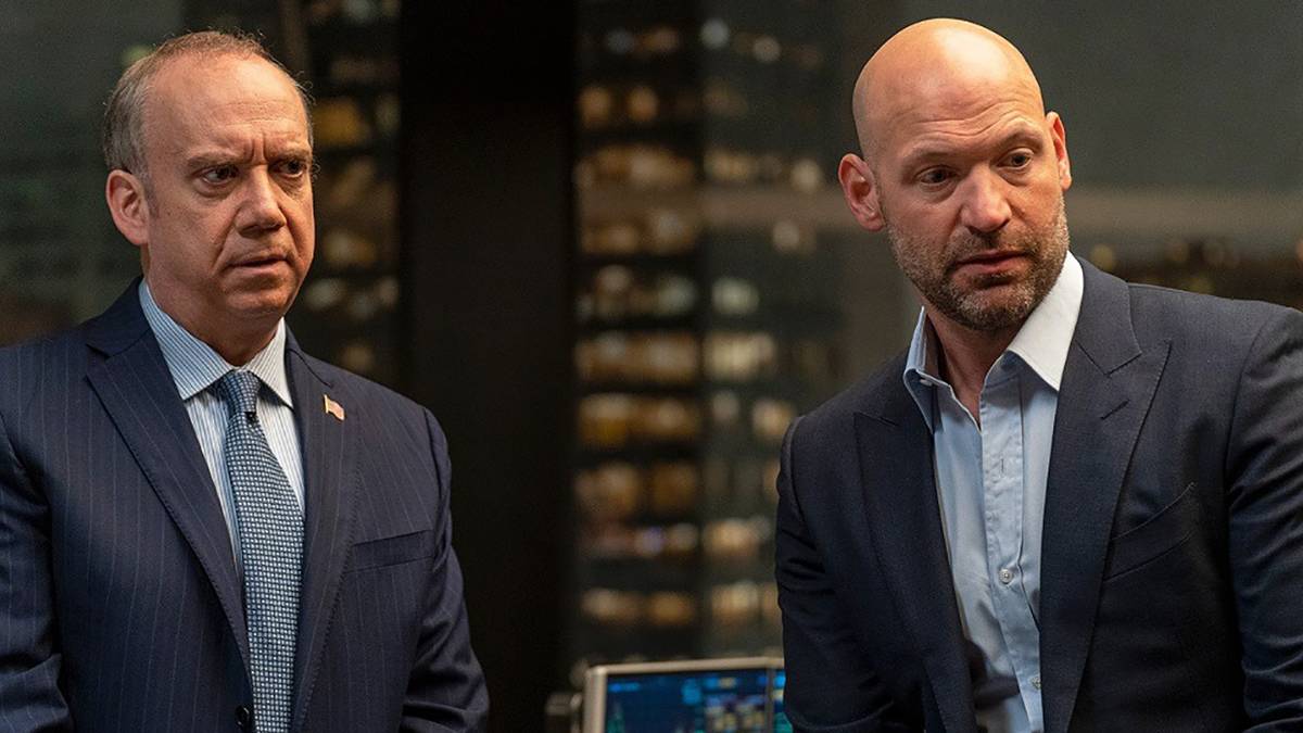 Corey Stoll and Paul Giamatti as Chuck and Mike from Billions standing next to one another, both looking angry.