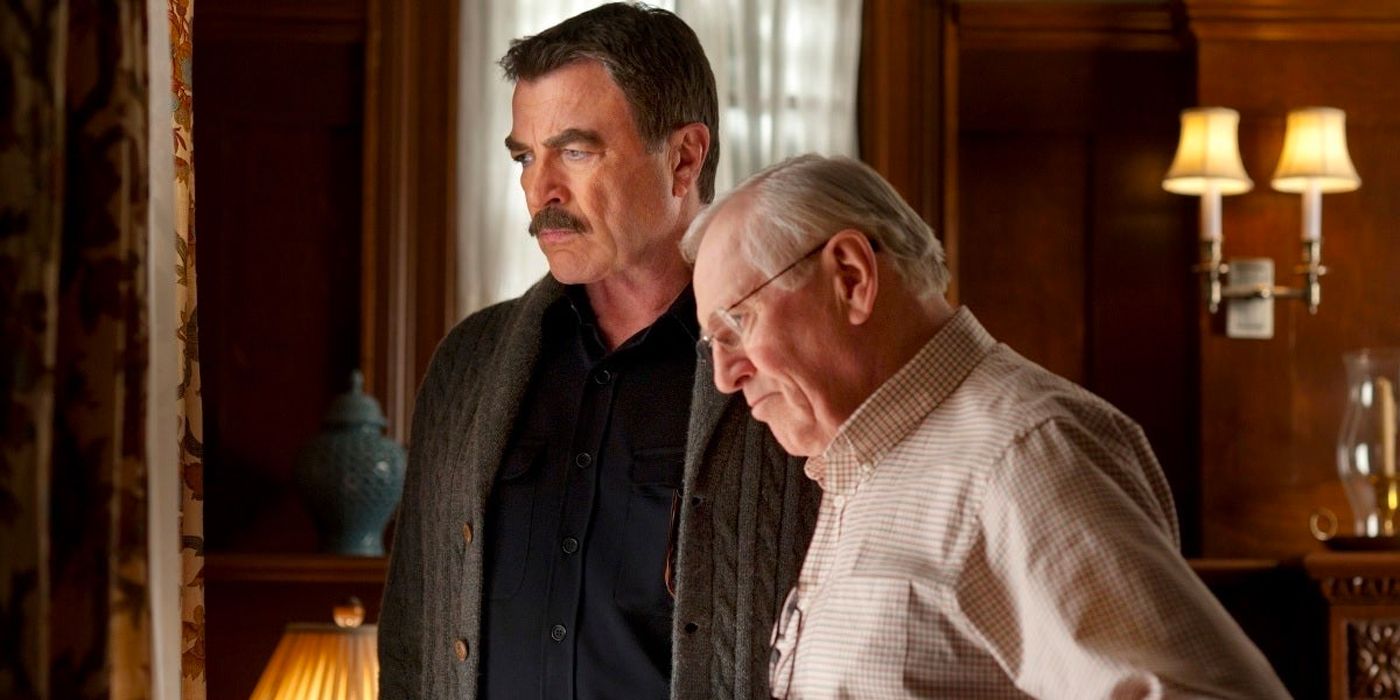 Frank (Tom Selleck) and Henry Reagan (Len Cariou) stand together in their family home looking out the window 