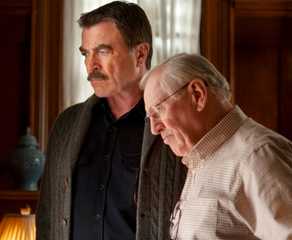 Frank (Tom Selleck) and Henry Reagan (Len Cariou) stand together in their family home looking out the window