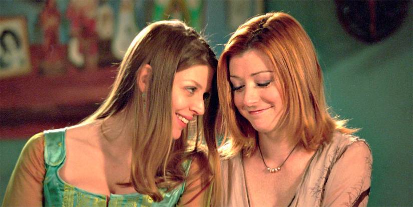 Alyson Hannigan as Willow and Amber Benson as Tara in Buffy the Vampire Slayer, looking at each other lovingly, and happy to be in each other's arms.