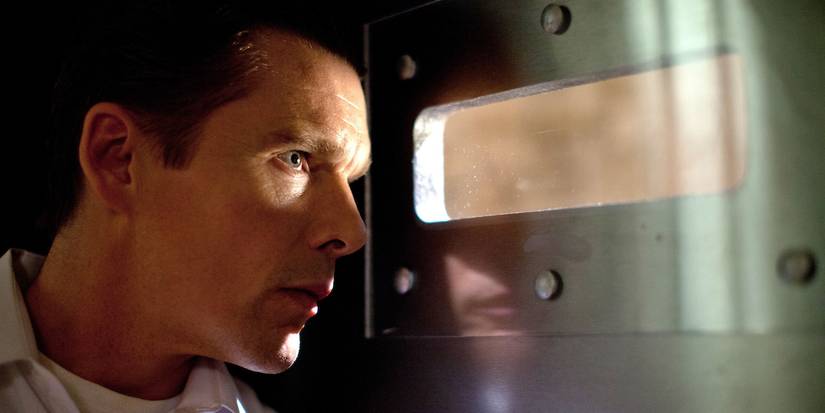 James Sandin, looking through a small window and looking worried in The Purge