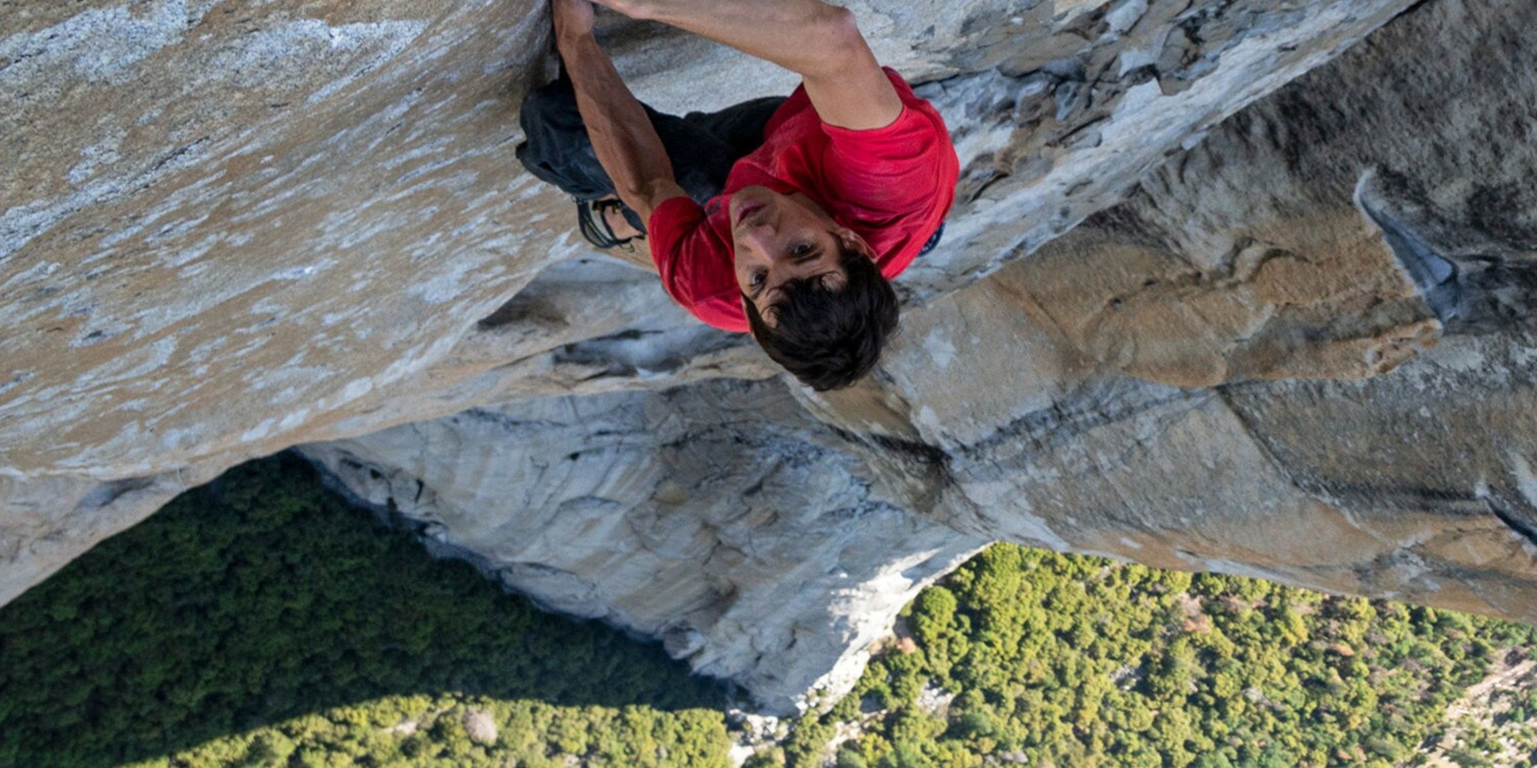 A man climbing the side of a mountain in Free Solo