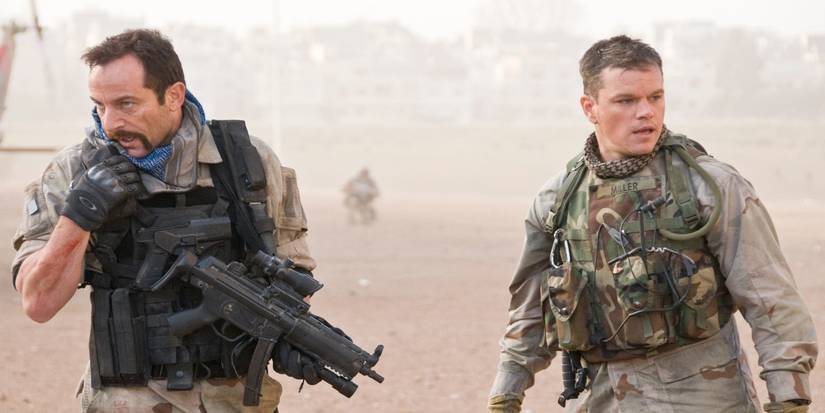 Jason Isaacs as Major Briggs and Matt Damon as Roy Miller standing together in an open field in Green Zone