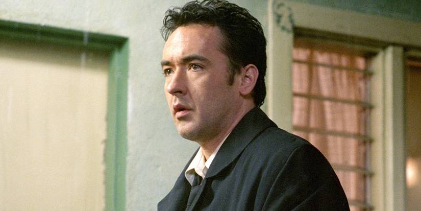 John Cusack staring slightly ahead and looking tense in Identity.