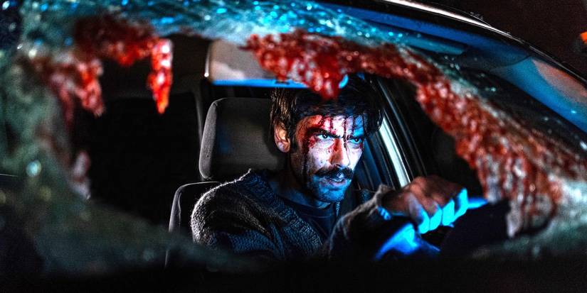 A bloodied Jimi is inside a car with the windshield broken in When Evil Lurks.