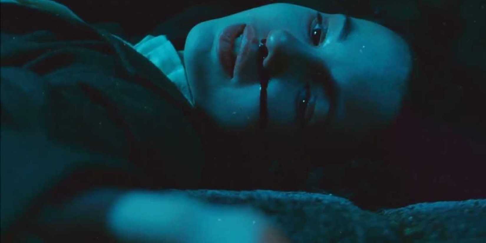Ivana Baquero as Ofelia lying on the ground with blood coming out of her nose in Pan's Labyrinth