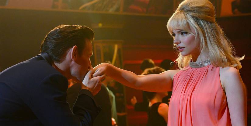 Matt Smith as Jack kissing Anya Taylor Joy as Sandie's hand in Last Night in Soho.