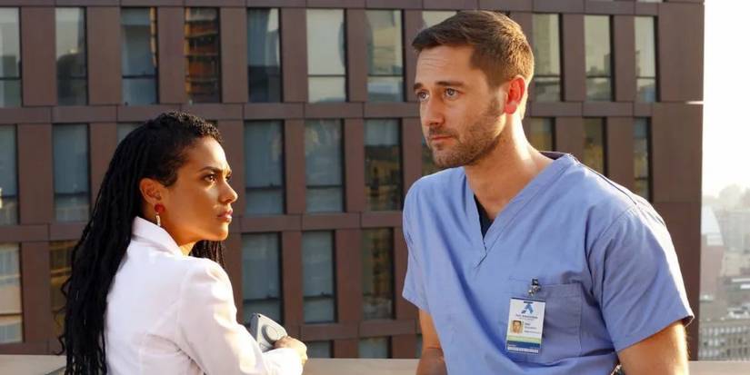 Freema Agyeman and Ryan Eggold stand on a roof in New Amsterdam
